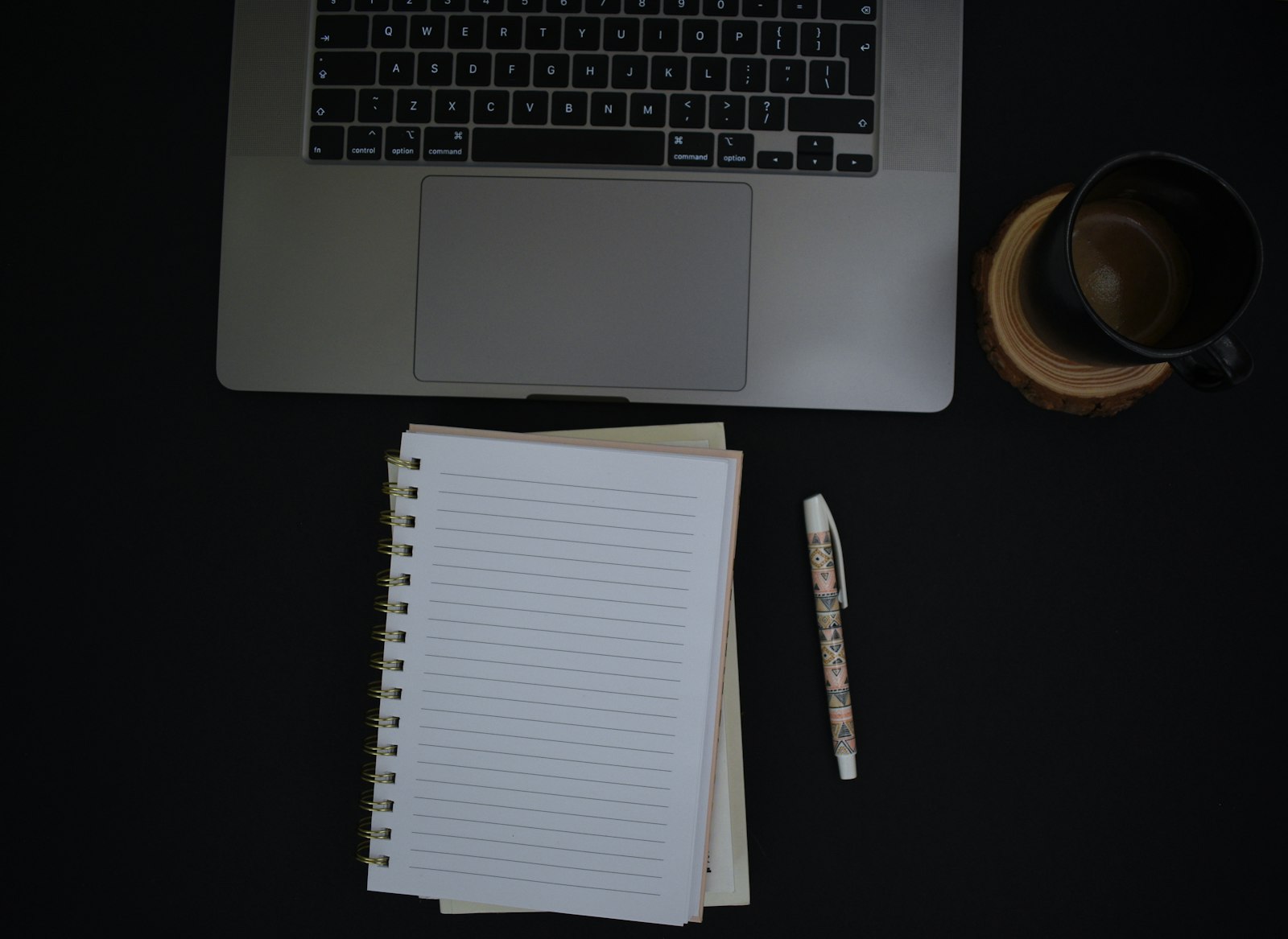 Notebook and pen on a desk, writing a cover letter