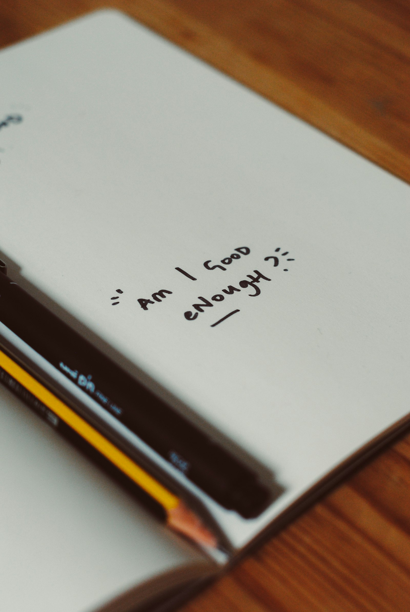 A pencil resting on a blank sheet of paper representing a resume draft