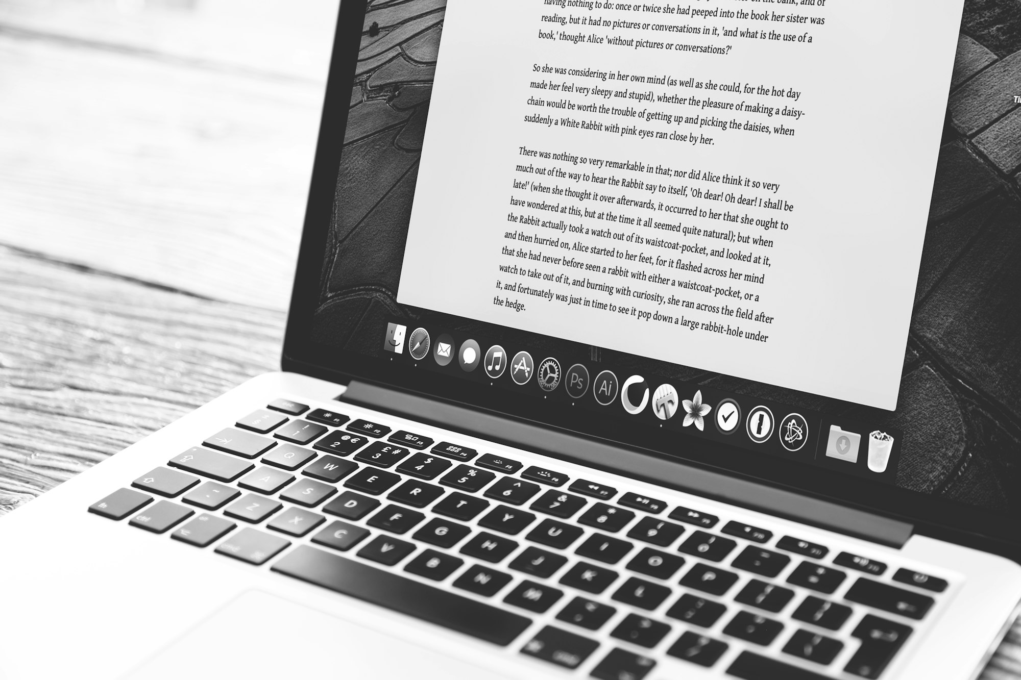 A silver MacBook open on a desk showing an application on screen