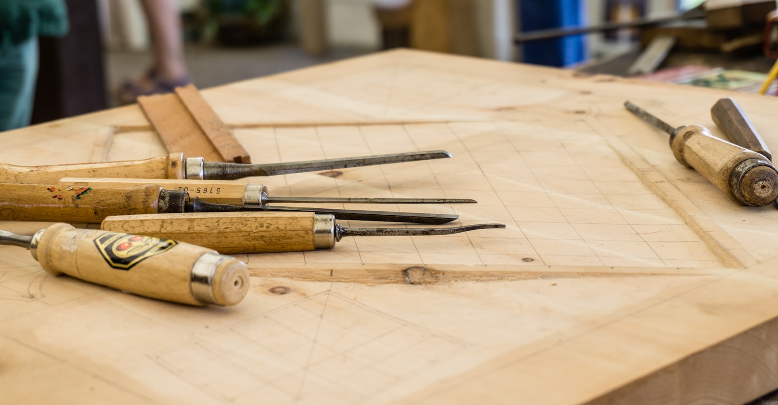 Hand woodworking tools laid out on a workbench