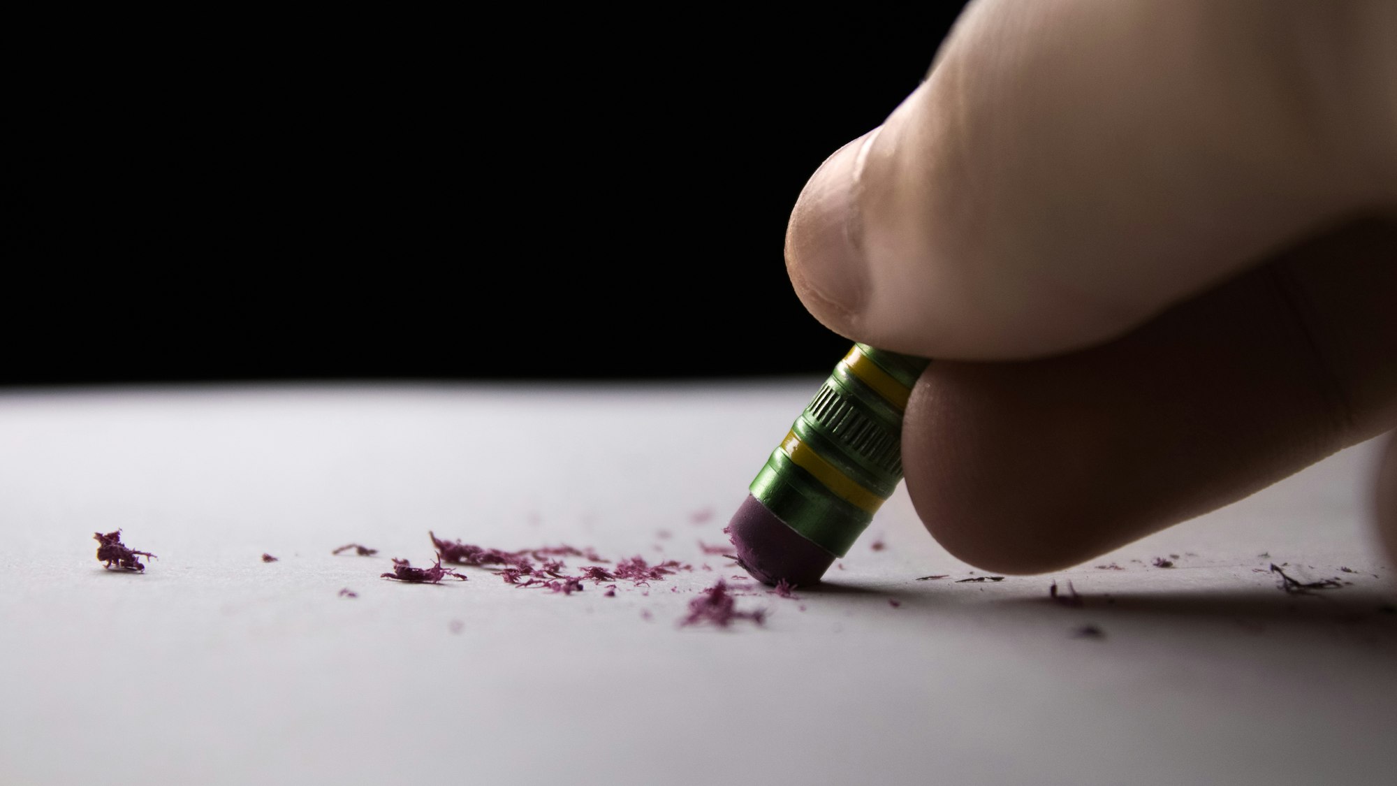 Close-up of a pencil eraser rubbing away pencil marks